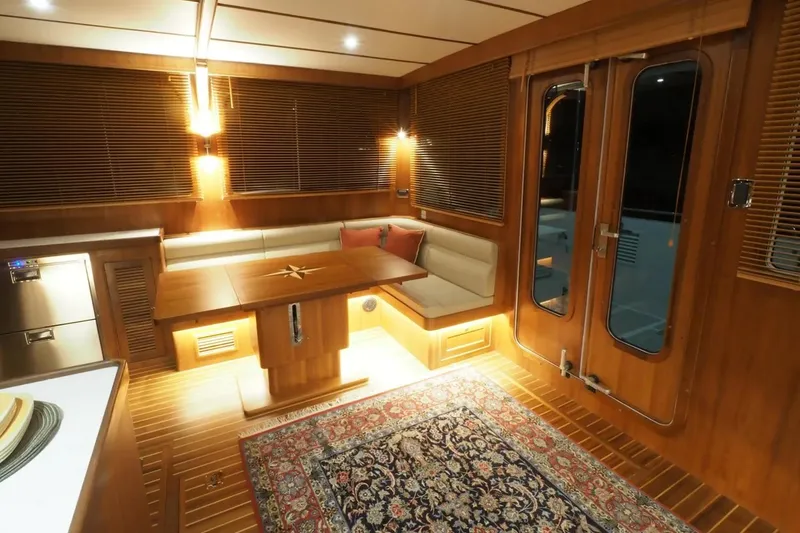 Slide: The Image of Luxurious interior of 2025 Helmsman Trawlers 46 Pilothouse with elegant wood finish and cozy seating. - 17