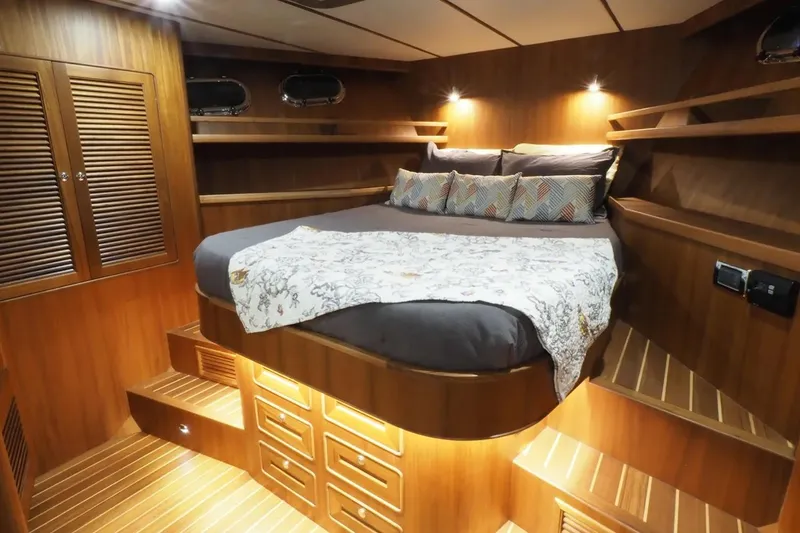 Slide: The Image of Luxurious cabin interior of 2025 Helmsman Trawlers 46 Pilothouse with wood finish and cozy bedding. - 25