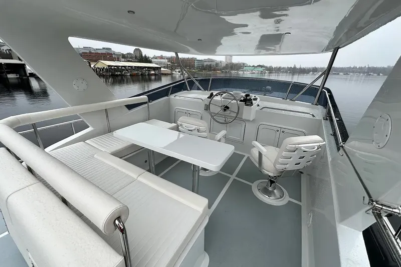 Slide: The Image of Helmsman Trawlers 46 Pilothouse 2025 yacht interior with seating and helm station. - 3