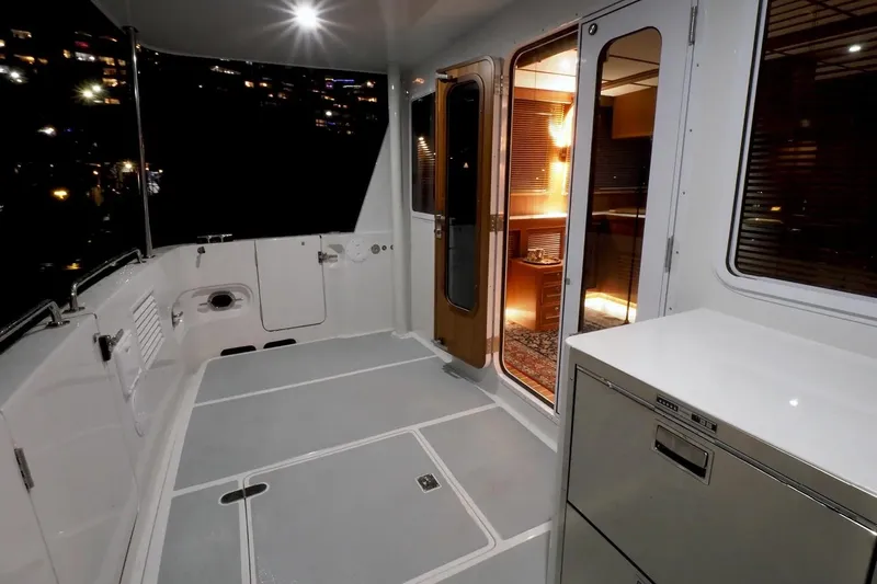 Slide: The Image of Helmsman Trawlers 46 Pilothouse 2025 interior with modern design and ambient lighting. - 6