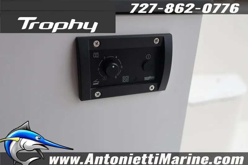 Slide: The Image of Control panel on 2026 Bayliner Trophy T25 Explorer boat, featuring contact details and logo. - 17