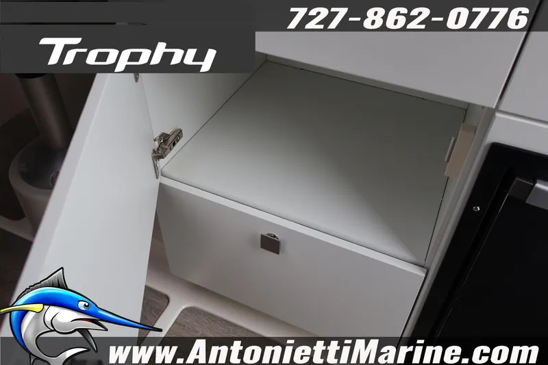Slide: The Image of 2026 Bayliner Trophy T25 Explorer interior storage compartment, Antonietti Marine branding. - 18
