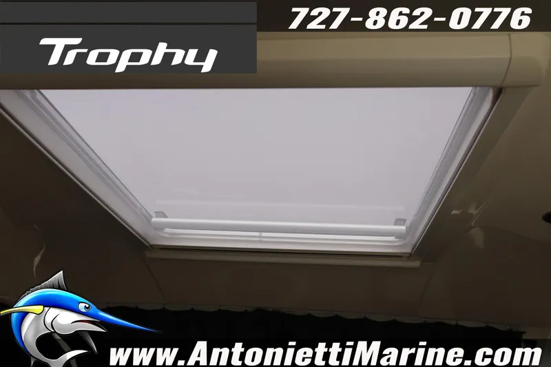 Slide: The Image of 2026 Bayliner Trophy T25 Explorer boat interior with skylight, Antonietti Marine contact details. - 21