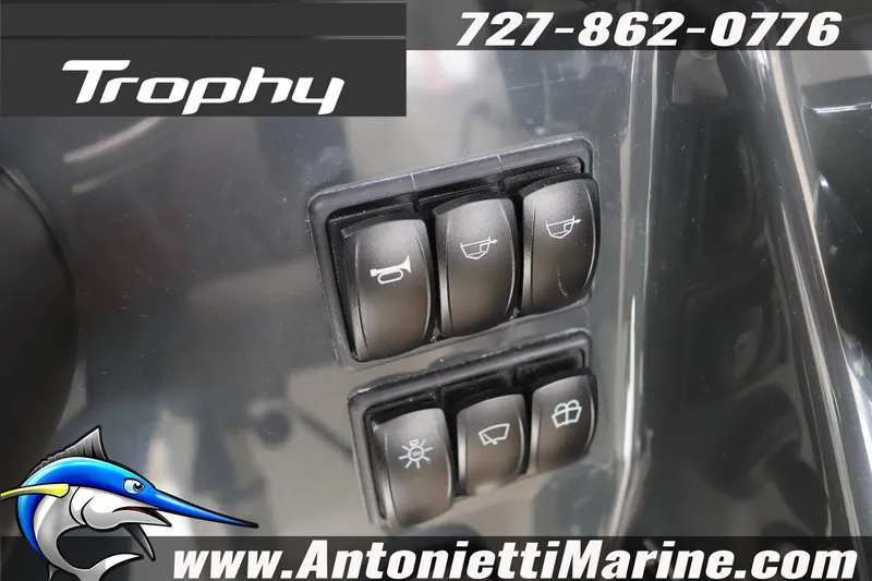 Slide: The Image of Control panel of 2026 Bayliner Trophy T25 Explorer boat with switches and logo. - 27