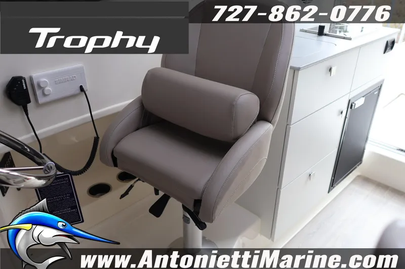 Slide: The Image of 2026 Bayliner Trophy T25 Explorer interior with helm seat and control panel. - 30
