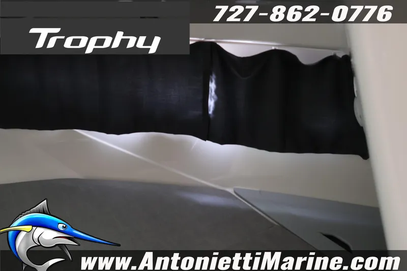 Slide: The Image of 2026 Bayliner Trophy T25 Explorer interior with black curtain, contact info, and logo. - 40