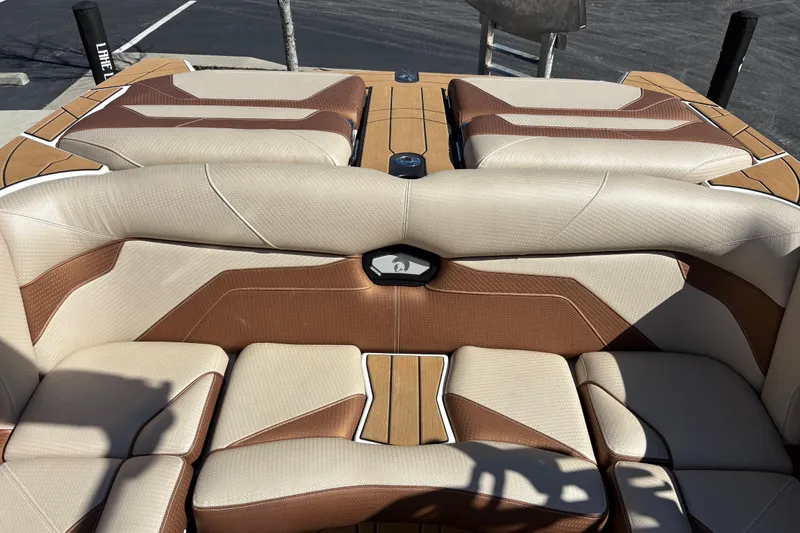 Slide: The Image of 2022 Centurion Ri245 boat interior with beige and brown seating, showcasing luxury design. - 11