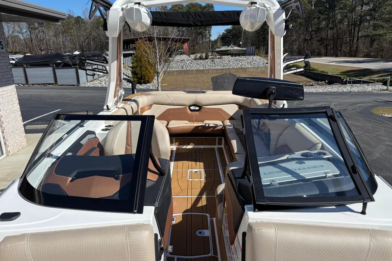 Slide: The Image of 2022 Centurion Ri245 boat interior with tan seating and open windshield. - 12