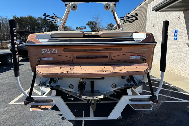 Slide: The Image of 2022 Centurion Ri245 boat rear view in parking lot, showcasing sleek design and features. - 3