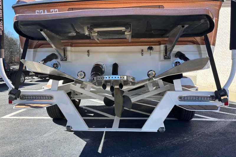 Slide: The Image of 2022 Centurion Ri245 boat rear view showing propeller and wakeboard features. - 4