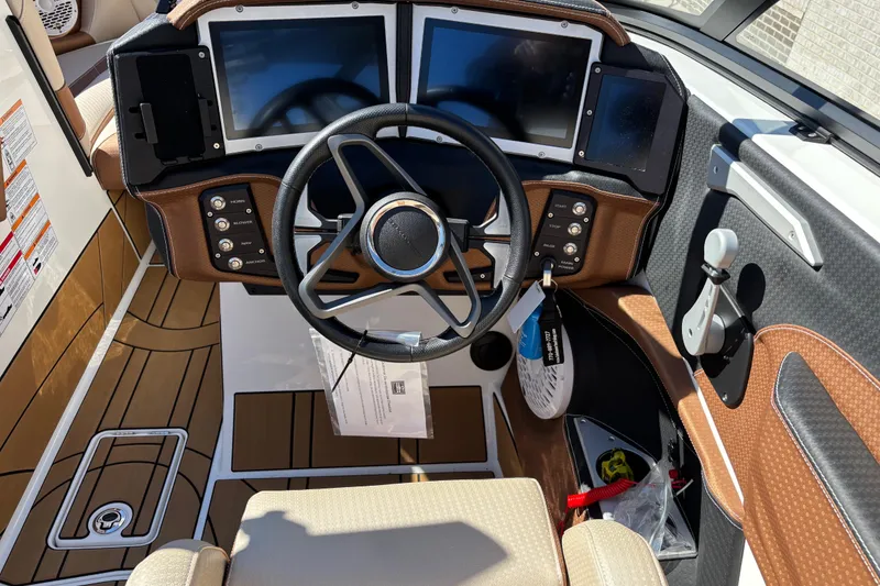 Slide: The Image of 2022 Centurion Ri245 boat dashboard with dual screens and modern controls. - 8
