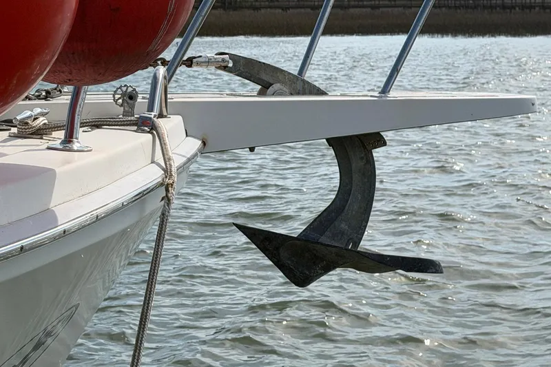 Slide: The Image of 1987 Viking 44 Motor Yacht anchor and bow detail on water. - 10