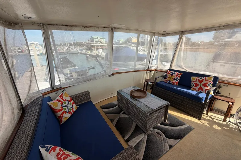 Slide: The Image of Enclosed deck of 1987 Viking 44 Motor Yacht with blue seating and colorful pillows. - 21