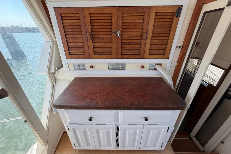 Slide: The Image of 1987 Viking 44 Motor Yacht interior with wooden cabinets and countertop. - 24