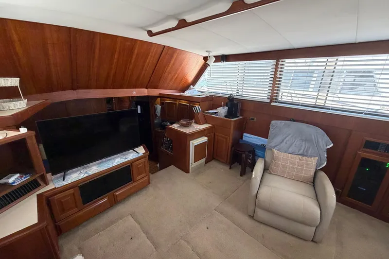 Slide: The Image of Interior of 1987 Viking 44 Motor Yacht with wood paneling and comfortable seating. - 41