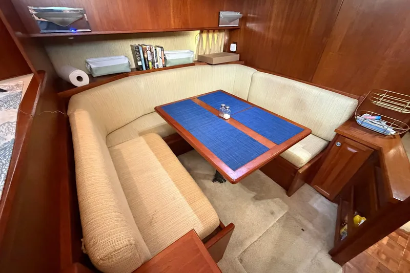 Slide: The Image of Cozy dining area in 1987 Viking 44 Motor Yacht with wooden table and cushioned seating. - 42