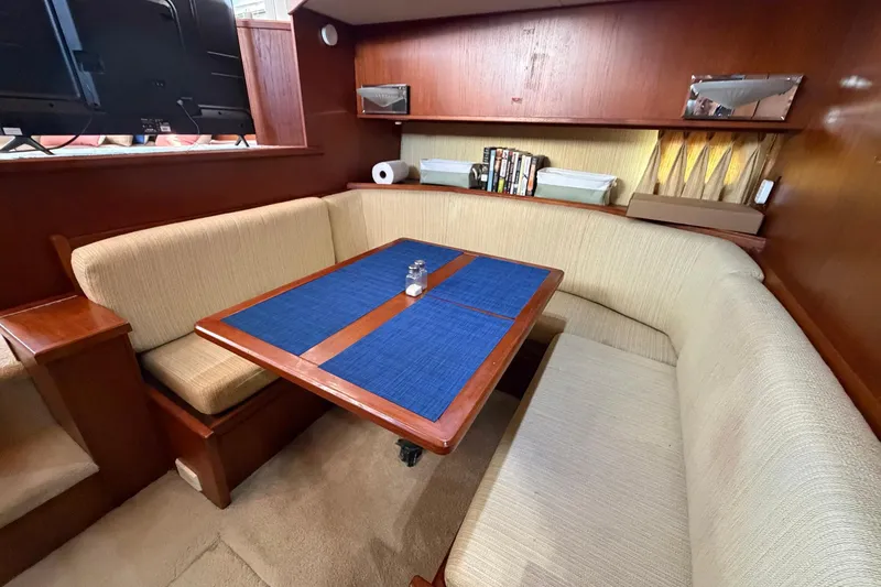 Slide: The Image of 1987 Viking 44 Motor Yacht interior with cozy dining area and wooden accents. - 43