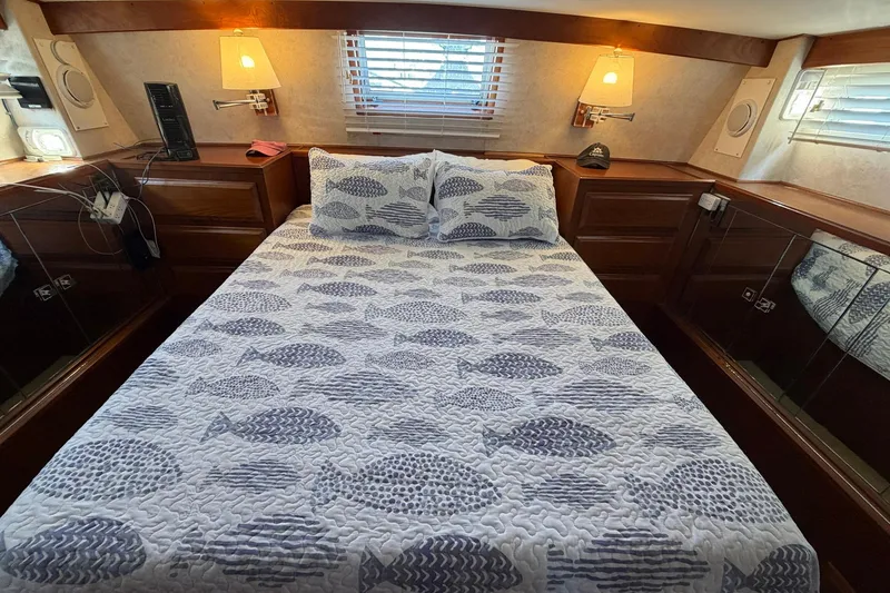Slide: The Image of Cozy bedroom in 1987 Viking 44 Motor Yacht with fish-patterned bedding. - 53