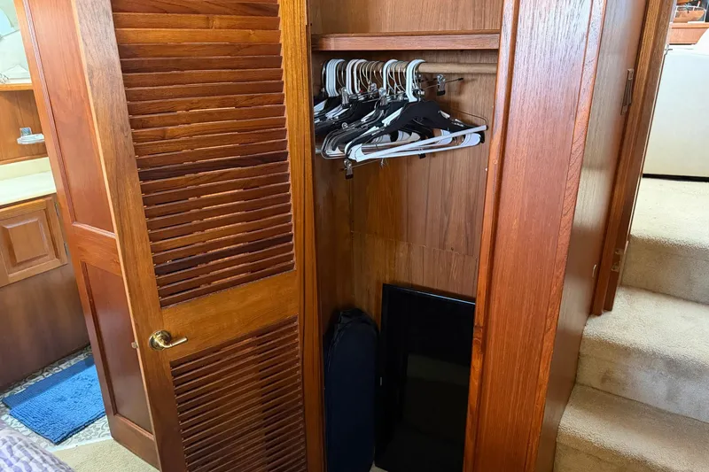 Slide: The Image of Wooden closet with hangers inside a 1987 Viking 44 Motor Yacht. - 58