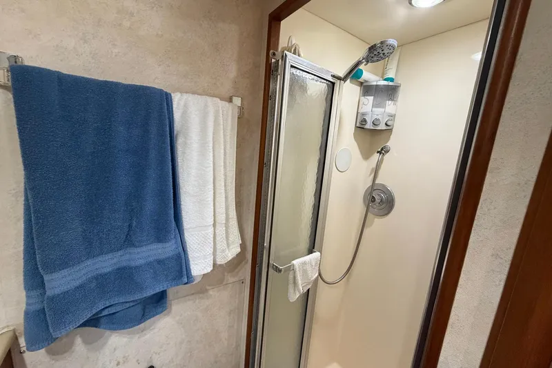 Slide: The Image of Shower area in 1987 Viking 44 Motor Yacht with towels and modern fixtures. - 60