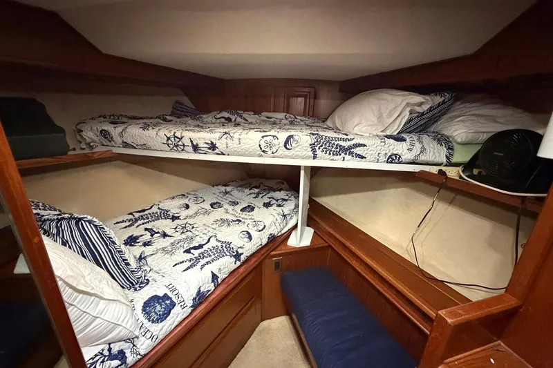 Slide: The Image of 1987 Viking 44 Motor Yacht cabin with bunk beds and nautical-themed bedding. - 61