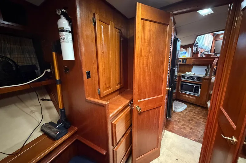 Slide: The Image of Interior of 1987 Viking 44 Motor Yacht with wooden cabinetry and kitchen view. - 63