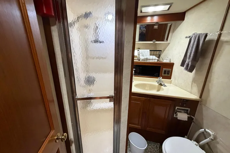 Slide: The Image of Bathroom interior of 1987 Viking 44 Motor Yacht with shower, sink, and toilet. - 64