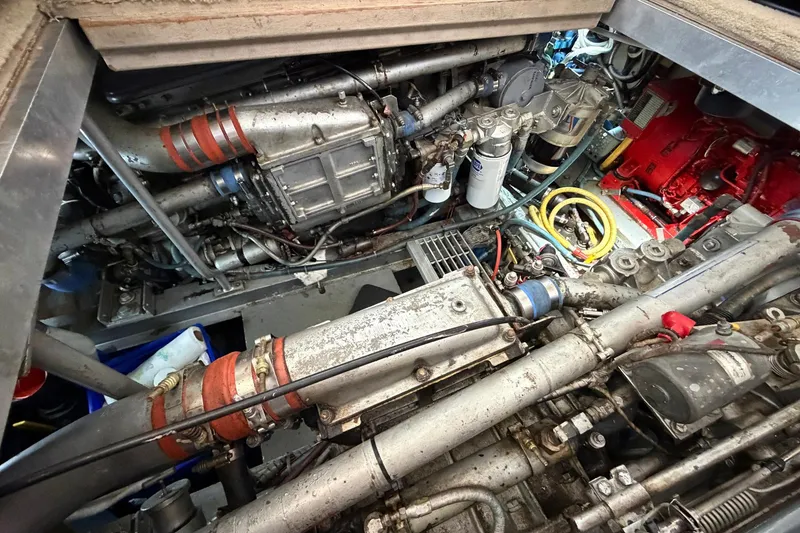 Slide: The Image of Engine room of a 1987 Viking 44 Motor Yacht, showcasing complex machinery and components. - 73