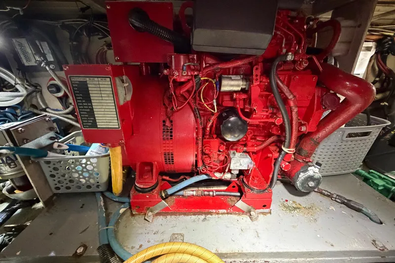 Slide: The Image of Engine room of 1987 Viking 44 Motor Yacht with red machinery and hoses. - 76