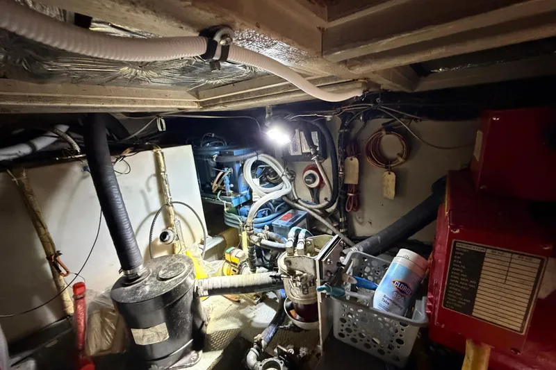 Slide: The Image of Engine room of a 1987 Viking 44 Motor Yacht, showcasing mechanical components and wiring. - 78
