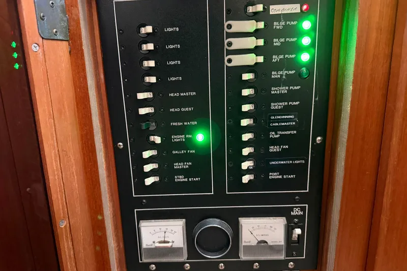 Slide: The Image of Control panel of a 1987 Viking 44 Motor Yacht with switches and indicators. - 82