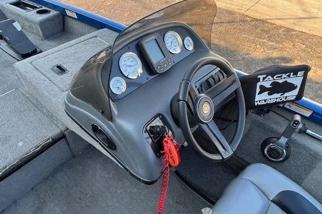 Slide: The Image of 2008 Triton TC-17 boat dashboard with steering wheel and gauges, featuring Tackle Warehouse sticker. - 16