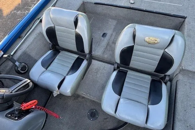 Slide: The Image of Two gray and black seats in a 2008 Triton TC-17 boat interior. - 18