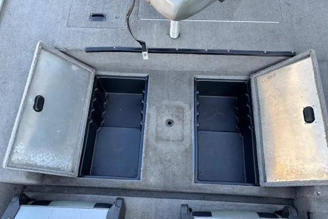 Slide: The Image of 2008 Triton TC-17 boat storage compartments with open lids, showcasing interior space. - 20