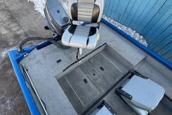 Slide: The Image of 2008 Triton TC-17 boat interior with seating and motor, parked on snowy ground. - 21
