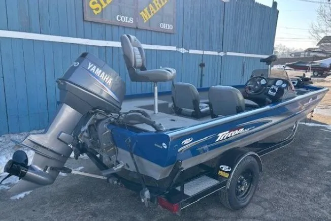 Slide: The Image of 2008 Triton TC-17 boat with Yamaha motor, parked outdoors near blue building. - 4