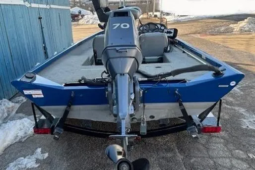 Slide: The Image of 2008 Triton TC-17 boat with 70 HP outboard motor, parked on a trailer. - 5