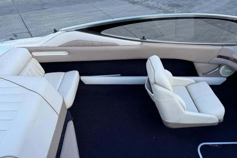 Slide: The Image of 1999 Regal 1900 LSR boat interior with white leather seats and sleek design. - 14
