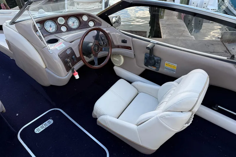 Slide: The Image of 1999 Regal 1900 LSR boat interior with steering wheel and white seating. - 16