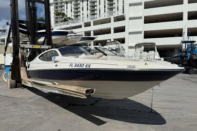 Slide: The Image of 1999 Regal 1900 LSR boat on forklift, marina background, sunny day. - 24