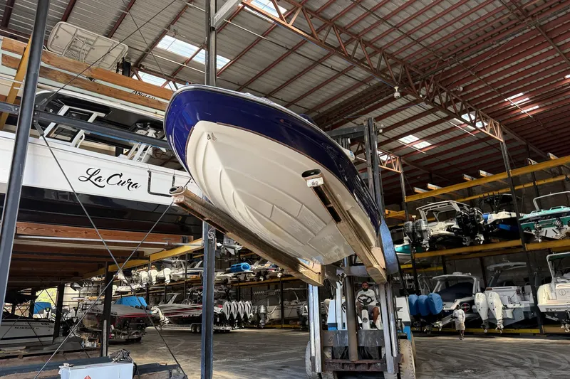 Slide: The Image of 1999 Regal 1900 LSR boat stored in a spacious indoor marina. - 29