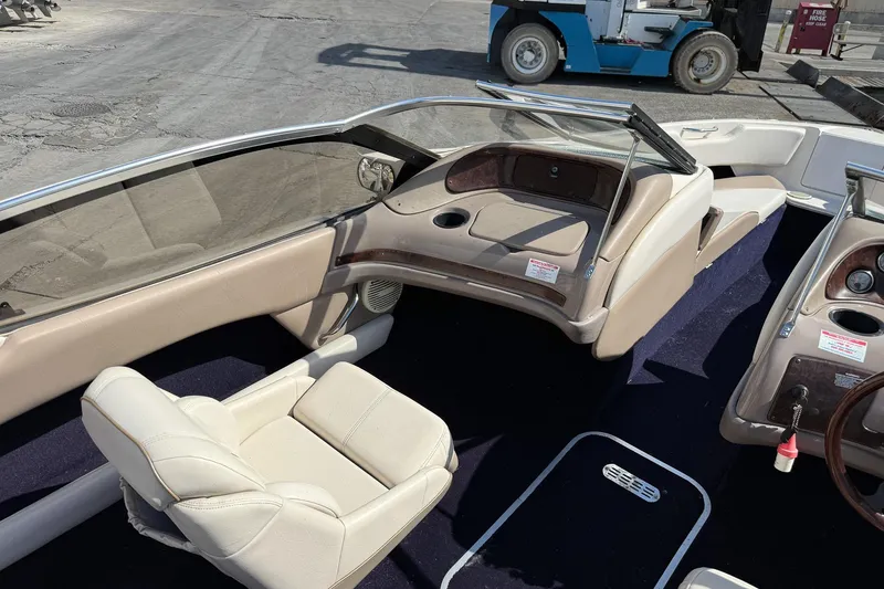 Slide: The Image of Interior of a 1999 Regal 1900 LSR boat with beige seating and dashboard. - 4