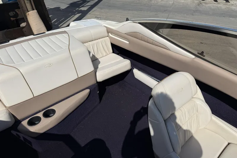 Slide: The Image of Interior of a 1999 Regal 1900 LSR boat with white leather seating. - 7