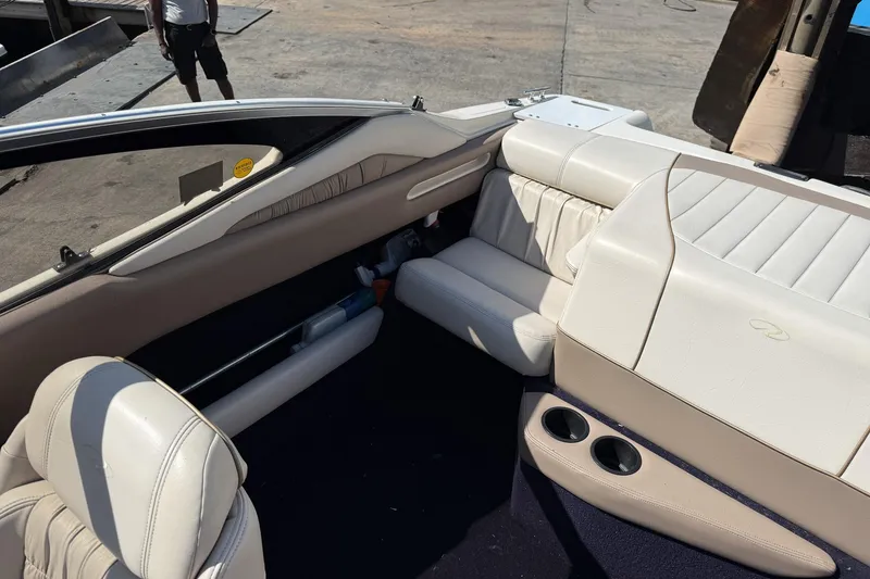 Slide: The Image of Interior of a 1999 Regal 1900 LSR boat with white leather seating. - 8