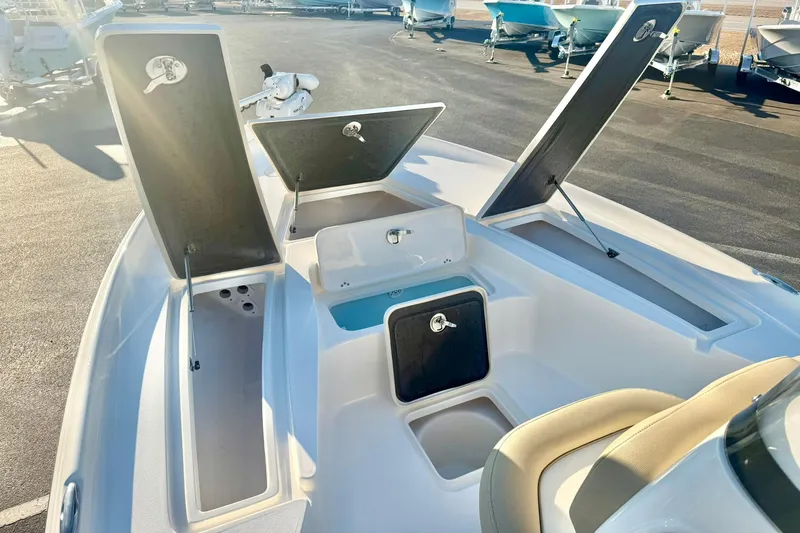 Slide: The Image of 2020 Key West 230 Bay Reef boat with open storage compartments on deck. - 12