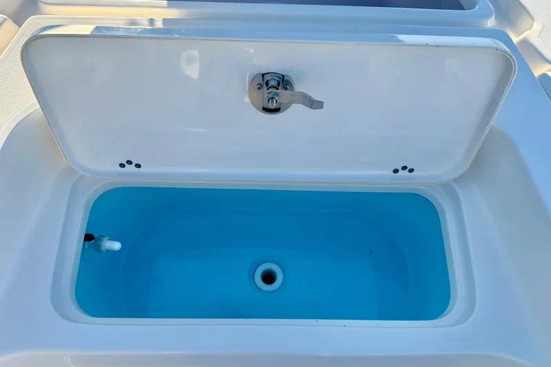 Slide: The Image of Livewell compartment on a 2020 Key West 230 Bay Reef boat, open lid, blue interior. - 17