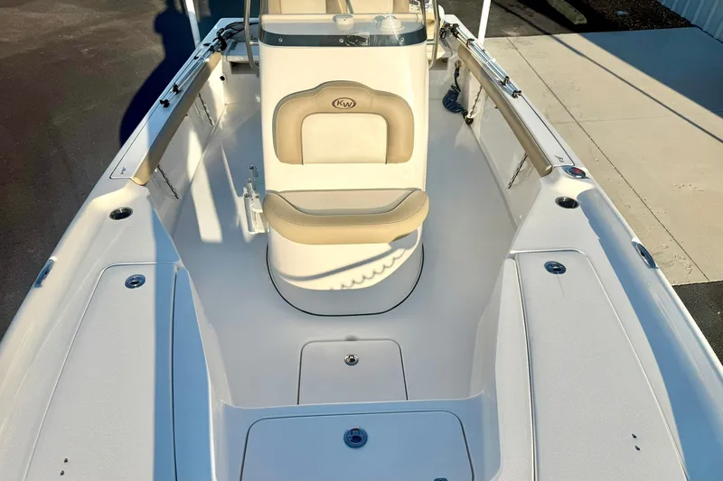 Slide: The Image of 2020 Key West 230 Bay Reef boat interior with seating and storage compartments. - 20
