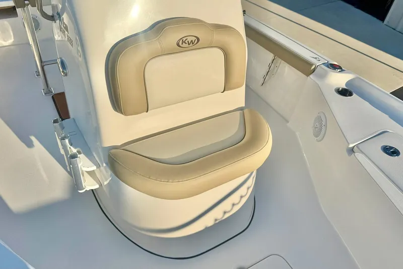 Slide: The Image of 2020 Key West 230 Bay Reef boat interior with beige cushioned seating. - 21