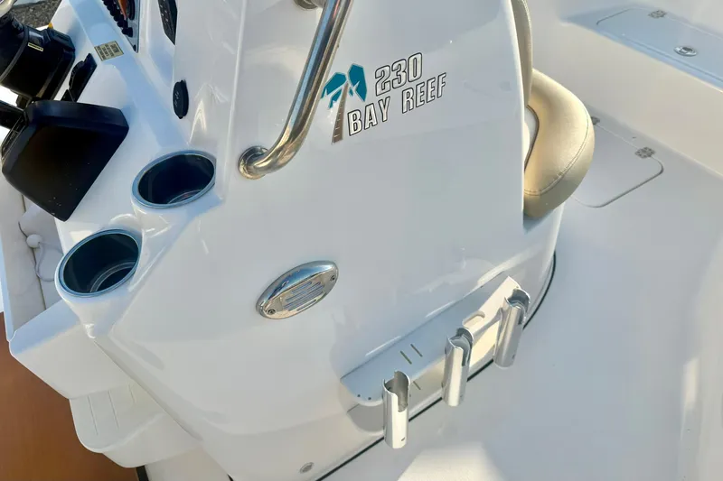 Slide: The Image of 2020 Key West 230 Bay Reef boat console with cup holders and rod holders. - 23