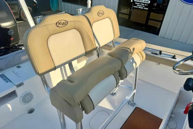 Slide: The Image of 2020 Key West 230 Bay Reef boat with beige cushioned seating and stainless steel fixtures. - 24